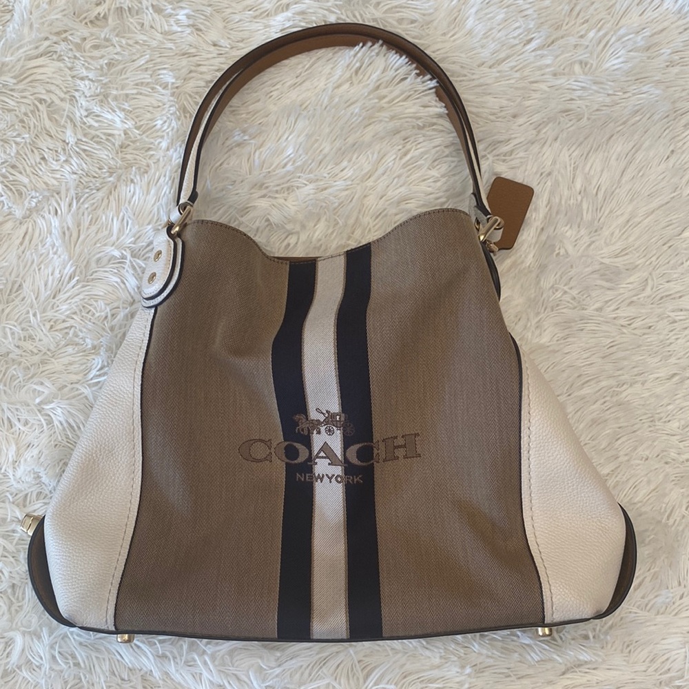 Coach shoulder handbag. 10.5inH 15inW. Cream leather w neutral color fabric.